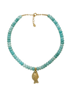 Turquoise beaded necklace with a gold fish pendant on a white background